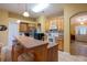 Open kitchen with breakfast bar, stainless fridge, white appliances, and wood cabinets at 232 Westchester Dr, Deland, FL 32724