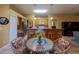 Open kitchen and dining area with wood cabinets and a breakfast bar at 232 Westchester Dr, Deland, FL 32724