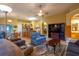 Inviting living room with a ceiling fan seamlessly connects to the kitchen with a breakfast bar at 232 Westchester Dr, Deland, FL 32724