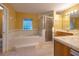 Bright bathroom featuring a soaking tub, separate shower, and marble countertops at 232 Westchester Dr, Deland, FL 32724