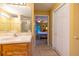Bathroom sink with marble countertop, wood cabinets and tile floors at 232 Westchester Dr, Deland, FL 32724