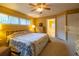 Comfortable bedroom with a ceiling fan, large window, and ensuite bathroom access at 232 Westchester Dr, Deland, FL 32724