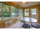 Inviting sunroom with tile flooring and large windows that overlook the landscaped backyard at 232 Westchester Dr, Deland, FL 32724