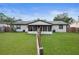 View of the screened in patio, backyard and fence at 2415 India Palm Dr, Edgewater, FL 32141