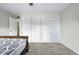 This bedroom features wood-look floors and ample storage with large closet with folding doors at 2415 India Palm Dr, Edgewater, FL 32141