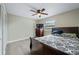This cozy bedroom features wood-look floors, a ceiling fan, and lots of natural light at 2415 India Palm Dr, Edgewater, FL 32141