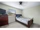 This bedroom features wood-look floors, a ceiling fan, and lots of natural light at 2415 India Palm Dr, Edgewater, FL 32141