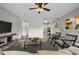 Open living room with stylish decor, wood floors, and convenient access to other rooms at 2415 India Palm Dr, Edgewater, FL 32141