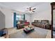 Comfortable living room offers lots of seating, a ceiling fan and luxury vinyl plank flooring at 2415 India Palm Dr, Edgewater, FL 32141
