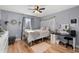 Cozy bedroom featuring hardwood floors, a ceiling fan, and decor at 2479 Vaughn Ave, Deltona, FL 32725