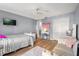 Bright bedroom with hardwood floors, TV, and modern decor at 2479 Vaughn Ave, Deltona, FL 32725