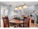 Inviting dining room with wood table, six chairs, and decorative lighting fixture at 2479 Vaughn Ave, Deltona, FL 32725