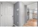 Bright hallway with white doors and access to the kitchen area with updated appliances at 2479 Vaughn Ave, Deltona, FL 32725