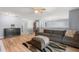 Comfortable living room featuring a large sofa, wood flooring, and neutral décor at 2479 Vaughn Ave, Deltona, FL 32725