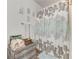 Clean bathroom showcasing a shower with a decorative curtain, fresh towels, and organized storage solutions at 2704 Oak Trail Run # 4, Port Orange, FL 32127