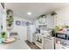 Well-lit kitchen showcasing white cabinets, a full suite of appliances, and stylish accents at 2704 Oak Trail Run # 4, Port Orange, FL 32127