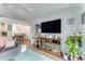 Living room featuring a large TV, view into the dining area, and modern decor, creating a comfortable living space at 2704 Oak Trail Run # 4, Port Orange, FL 32127