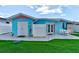 A meticulously maintained backyard offers a clean patio and lush artificial turf at 28 River Dr, Ormond Beach, FL 32176