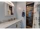 Bathroom featuring a white cabinet with a marble countertop and updated shower stall with brown tile at 28 River Dr, Ormond Beach, FL 32176