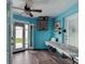 Bright bonus room features wood-look tile floor, ceiling fan and convenient access to the outdoors at 28 River Dr, Ormond Beach, FL 32176