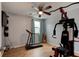Exercise room with updated wood-look tile, ceiling fan, a treadmill, and exercise machine at 28 River Dr, Ormond Beach, FL 32176