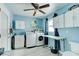 Laundry room featuring modern appliances, a utility sink, plenty of cabinet storage, and a ceiling fan at 28 River Dr, Ormond Beach, FL 32176