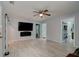 Spacious living room featuring tile floors and a modern fireplace, perfect for relaxing and entertaining at 28 River Dr, Ormond Beach, FL 32176