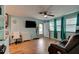 Bright living room with wood-look tile flooring, ceiling fan, and comfortable seating at 28 River Dr, Ormond Beach, FL 32176