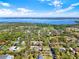 This aerial view displays a neighborhood with homes featuring expansive yards, mature trees, and unique architectural styles at 29127 Old E Ml, Tavares, FL 32778