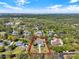 Expansive aerial view showcases a neighborhood with lush green landscaping with property lines outlined in red at 29127 Old E Ml, Tavares, FL 32778