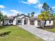 Beautiful home featuring three car garage, front sitting area, and stone paver driveway at 29127 Old E Ml, Tavares, FL 32778