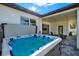 Relaxing hot tub on a patio with covered outdoor seating area at 29127 Old E Ml, Tavares, FL 32778