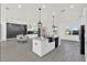 Modern white kitchen featuring marble island and counters, stainless appliances, and open layout at 29127 Old E Ml, Tavares, FL 32778