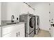The laundry room features front-loading washer and dryer units with a sink at 29127 Old E Ml, Tavares, FL 32778