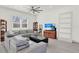 Bright living room featuring a large sectional couch, ceiling fan, and tile floors at 29127 Old E Ml, Tavares, FL 32778