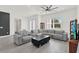 Bright living room featuring a large sectional couch, ceiling fan, and tile floors at 29127 Old E Ml, Tavares, FL 32778