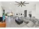 Open floor plan living room area with large couch adjacent to kitchen and dining area at 29127 Old E Ml, Tavares, FL 32778