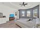 Bright main bedroom features gray accent wall, tray ceiling, and natural light at 29127 Old E Ml, Tavares, FL 32778