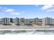Expansive beachfront view showcases the white condominium buildings against a clear blue sky at 2967 S Atlantic Ave # 301, Daytona Beach Shores, FL 32118