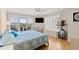 This bedroom features balcony access, a mounted TV, and sun-filled windows with bench seating at 2967 S Atlantic Ave # 301, Daytona Beach Shores, FL 32118