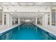 Clean indoor swimming pool with blue tiled trim and bright lighting at 2967 S Atlantic Ave # 301, Daytona Beach Shores, FL 32118