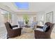 Bright sitting area boasts a skylight, comfortable seating, and views of palm trees at 2967 S Atlantic Ave # 301, Daytona Beach Shores, FL 32118