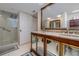 Bathroom with double vanity, large mirror, and a glass-enclosed shower at 2967 S Atlantic Ave # 301, Daytona Beach Shores, FL 32118
