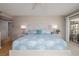 The spacious bedroom features a ceiling fan, a decorative headboard, and access to a private balcony at 2967 S Atlantic Ave # 301, Daytona Beach Shores, FL 32118