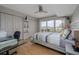 The bedroom features a ceiling fan, large closets, a glass top desk, and a view of the city at 2967 S Atlantic Ave # 301, Daytona Beach Shores, FL 32118