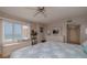 This bedroom features a window seat overlooking the ocean, a ceiling fan, and hardwood flooring at 2967 S Atlantic Ave # 301, Daytona Beach Shores, FL 32118