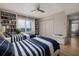 This bright bedroom has twin beds, custom built-ins, and beautiful hardwood floors at 2967 S Atlantic Ave # 301, Daytona Beach Shores, FL 32118