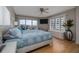 This bedroom has large windows with city views, a ceiling fan, and beautiful hardwood floors at 2967 S Atlantic Ave # 301, Daytona Beach Shores, FL 32118
