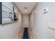 Bright hallway features an art piece, natural wood floors, and a closet at 2967 S Atlantic Ave # 301, Daytona Beach Shores, FL 32118