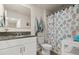 Bathroom with vanity, granite countertop, decorative shower curtain and toilet at 3075 Meleto Blvd, New Smyrna Beach, FL 32168